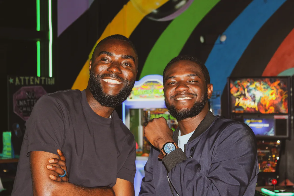 Two Manna House members smiling at a casual social gathering