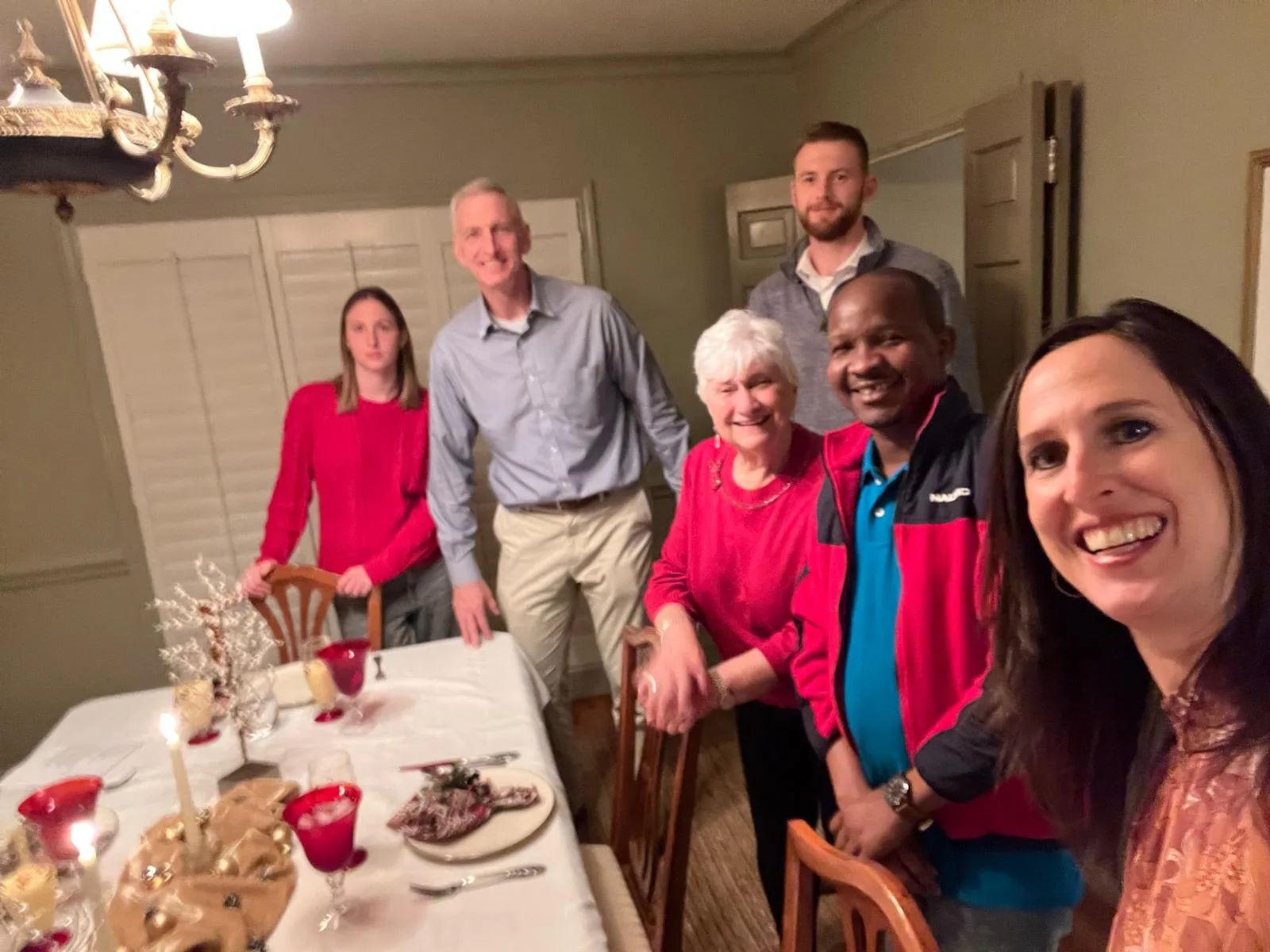 Manna House host family gathering around a table